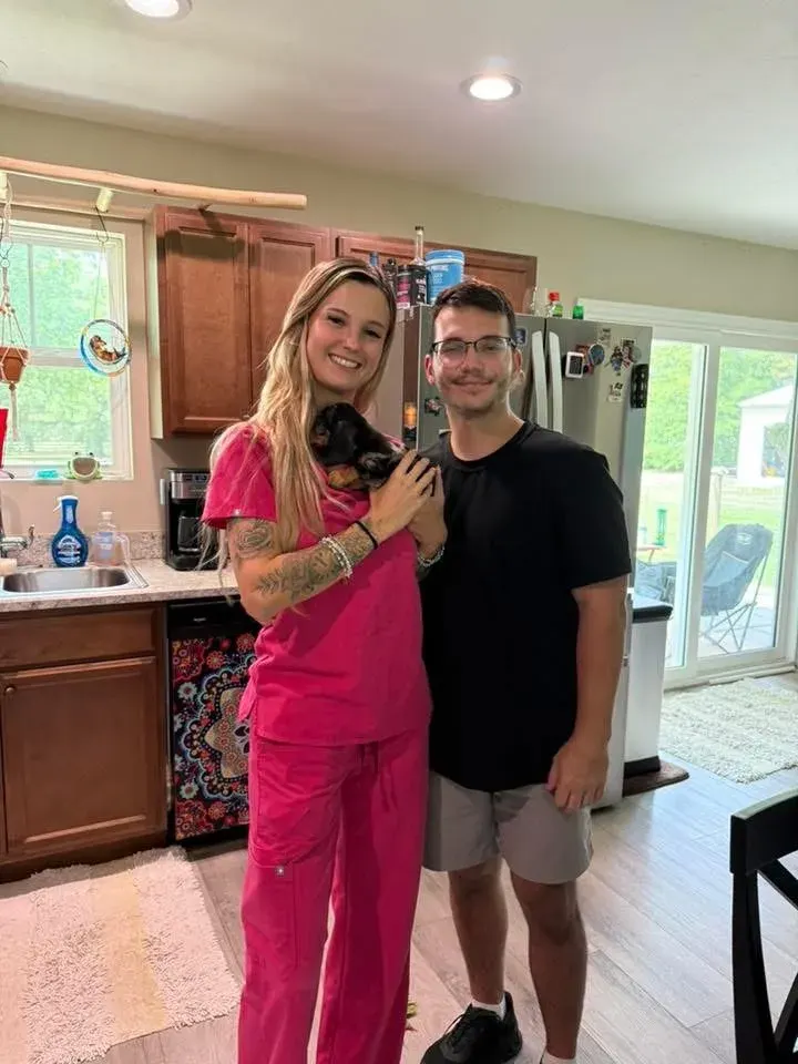 A family picking up their Miniature Dachshund puppy at Irish Rose Acres