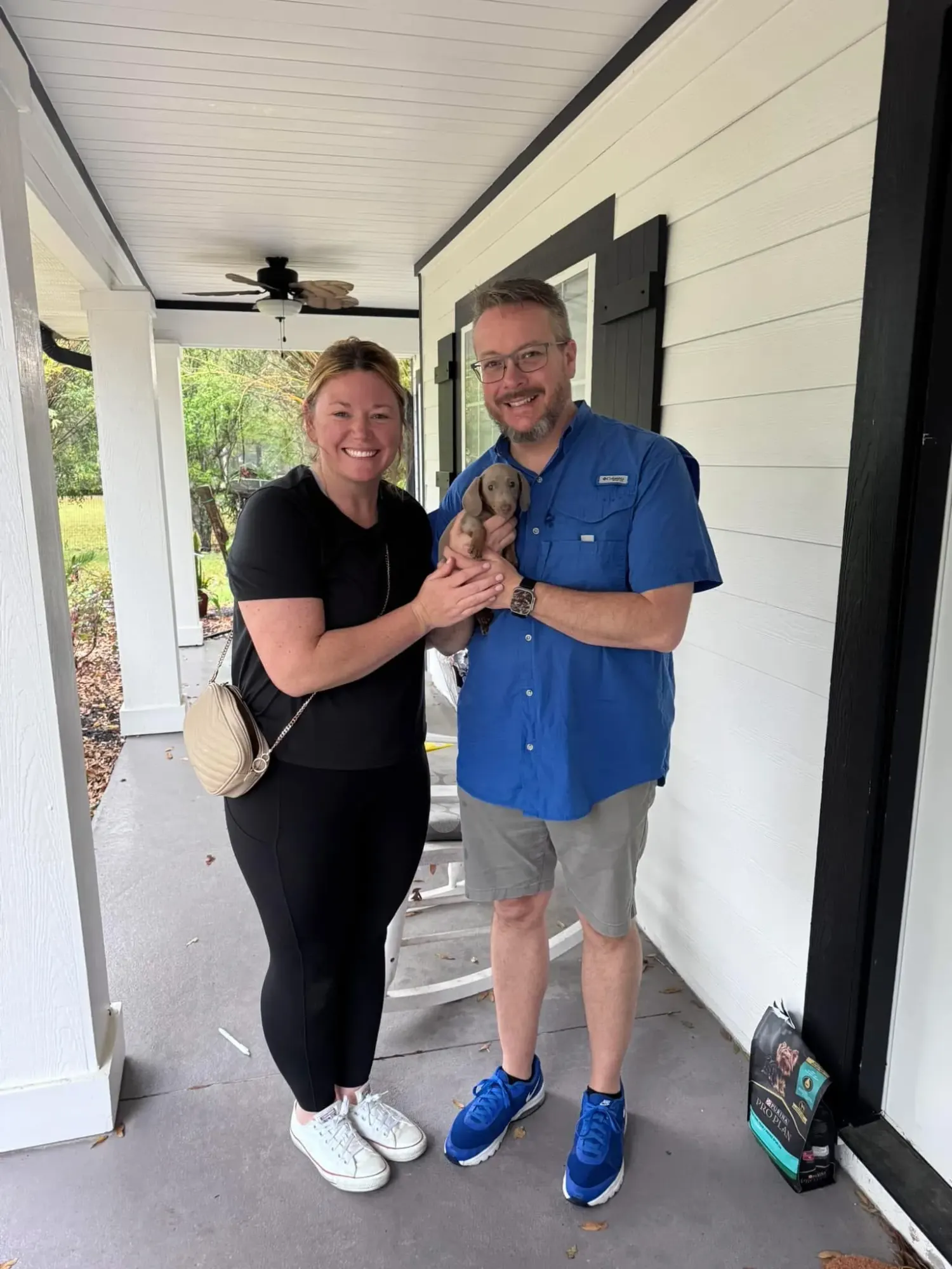 A family picking up their Miniature Dachshund puppy at Irish Rose Acres