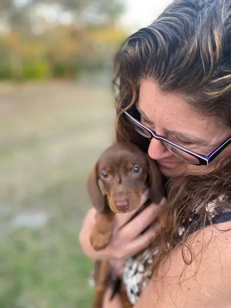 A family picking up their Miniature Dachshund puppy at Irish Rose Acres