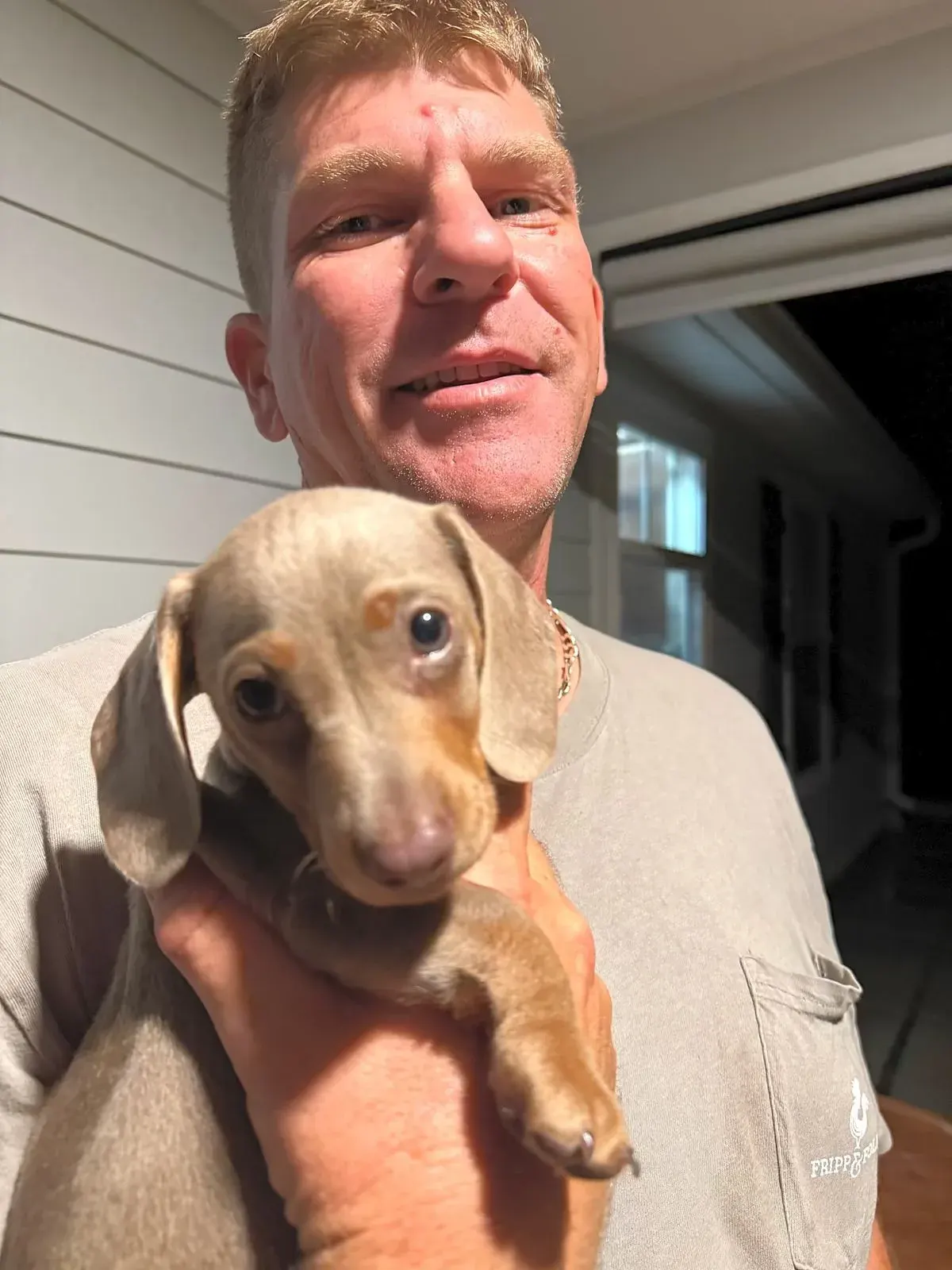 Kelli's husband with a dapple Miniature Dachshund